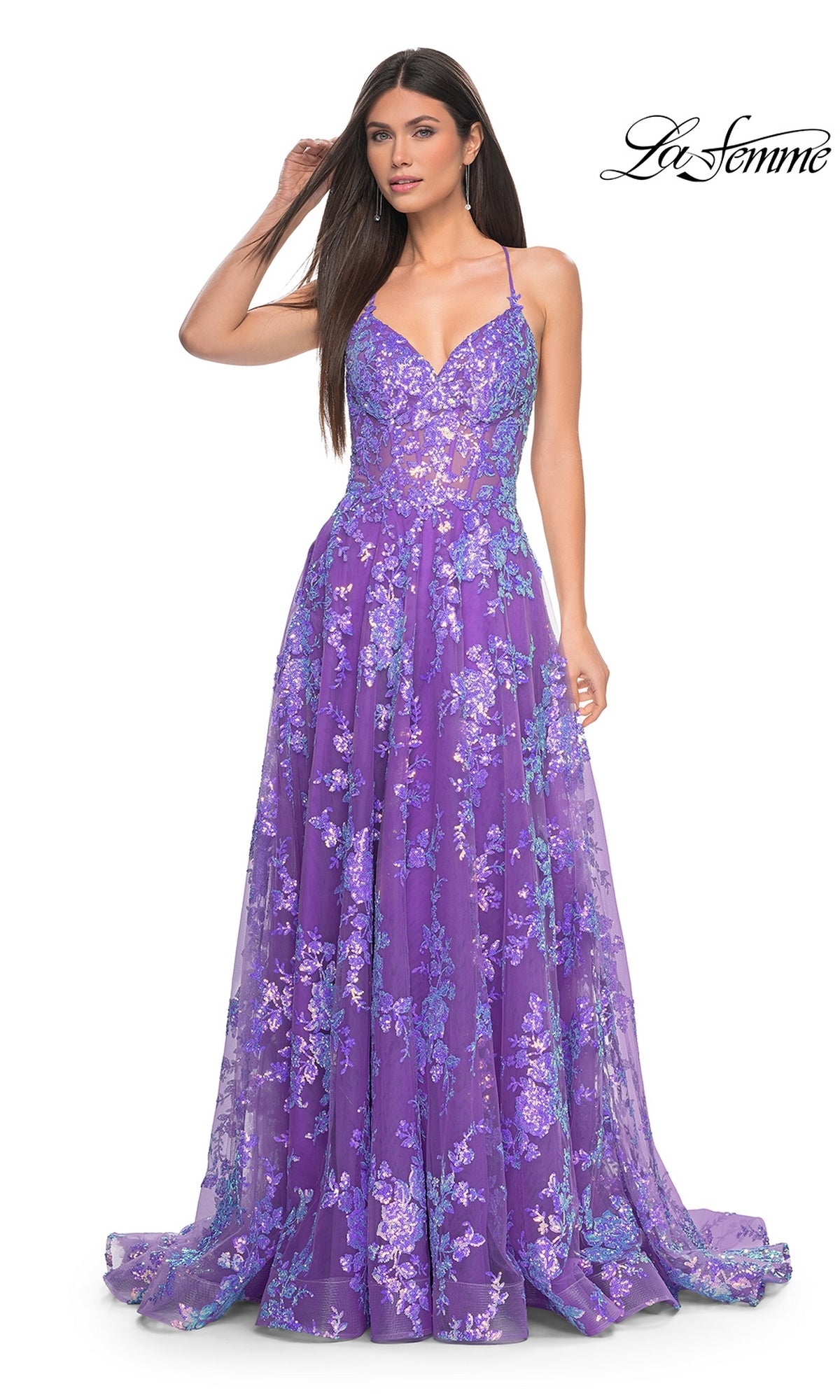 A woman models the La Femme Sequin-Lace Long Purple Prom Dress 32291, featuring thin straps, a fitted bodice, and blue and lavender sequin-lace appliques that stand out against a plain white background.